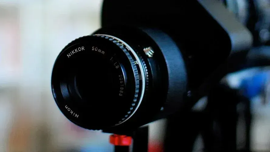 a photo of a SONY camera with a Nikkor lens mounted on it